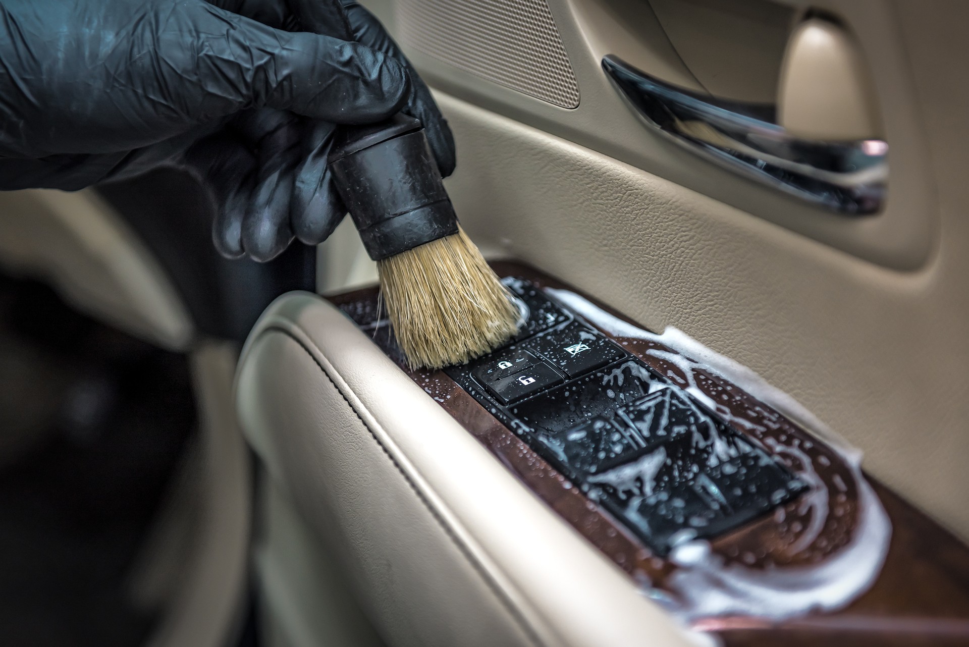 Specialist cleaning car with sud and brush. Car detailing. Selective focus. Car detailing. Carwash and cleaning solution concept